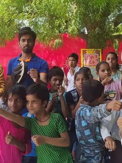 A group of young, determined students showing off their fighting stance after a self-defence session at their school camp.