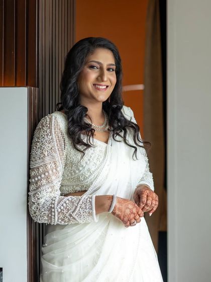 A confident and happy portrait of the bride. Her makeup is subtle yet effective, giving her a radiant and polished look.
