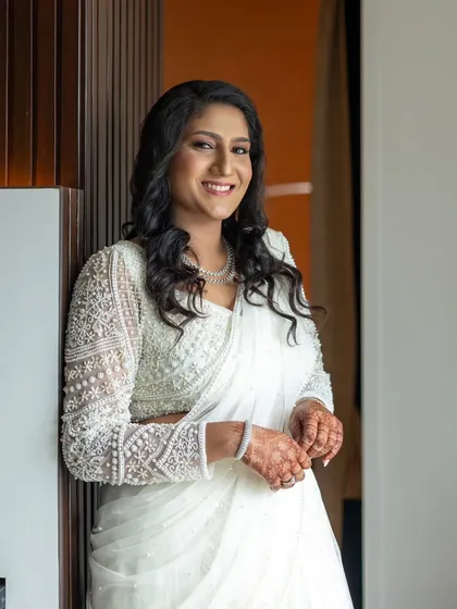 An ethereal engagement look in a white saree. The makeup is kept timeless and elegant to let the bride's natural radiance shine.
