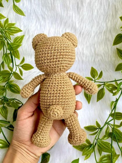 A classic teddy bear, a timeless gift for any age. This one is shown with a red ribbon, a black tie for 'Daddy Bear', and with expressive green eyes. They are soft, cuddly, and made to be loved.