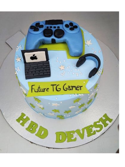 A cake for a future gamer, decorated with a fondant controller and laptop. This is an eggless black forest cake.