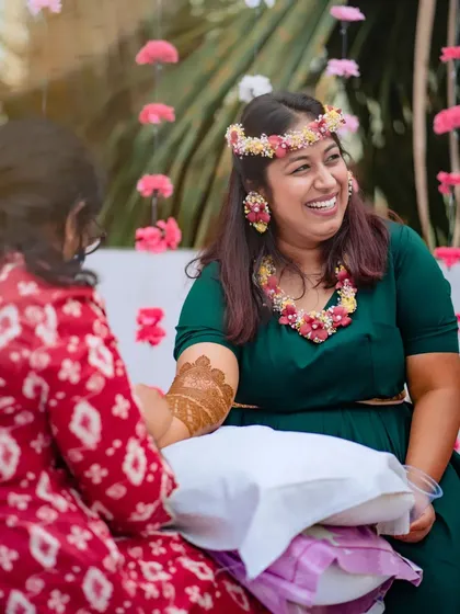 A shot capturing the application process during a lively mehndi party, showing my focus even amidst the celebration.