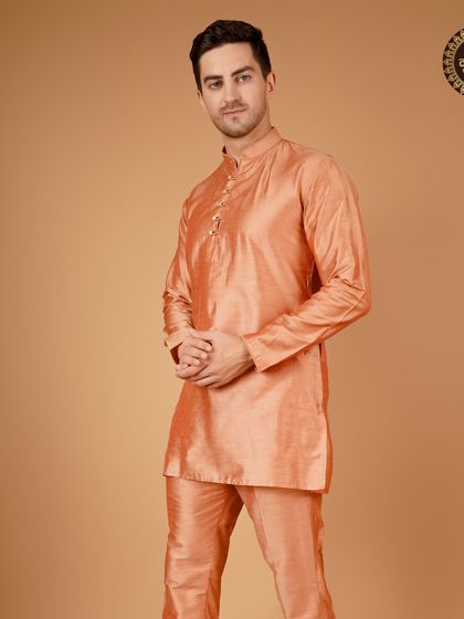 An elegant orange silk kurta set, a vibrant and celebratory choice for any festive event.