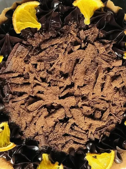 This close-up highlights the deep, rich color of the chocolate and the vibrant, juicy appearance of the candied orange.