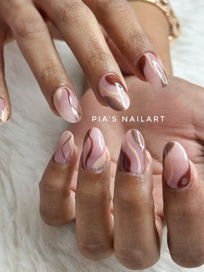 A classic swirl design on short acrylic extensions, using a beautiful palette of brown and nude tones.