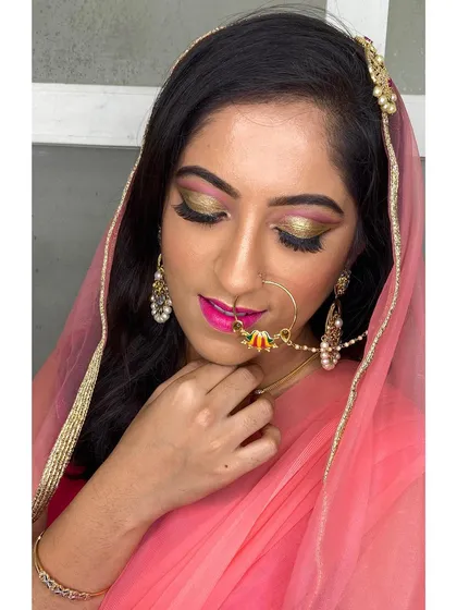 I adore creating glamorous Muslim bridal looks. This style features dramatic gold and pink glittery eyes, sharp winged liner, and a bold pink lip, all perfectly coordinated with the bride's jewellery and delicate dupatta.