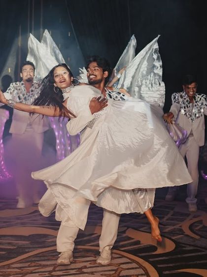 The professional dancers who added to the grandeur of the couple's entry, using illuminated fans and wing-like props to create a visual spectacle.