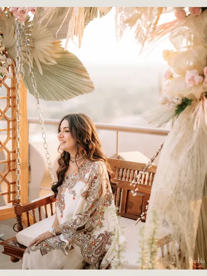 Basking in the golden hour glow at Fairmont Jaipur. This candid shot of the bride on a swing captures a moment of pure, serene happiness.