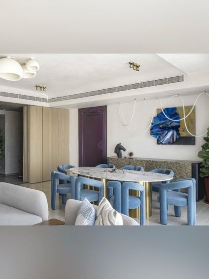 The full dining room view, where the blue of my sculpture echoes the color of the chairs, tying the whole design together.