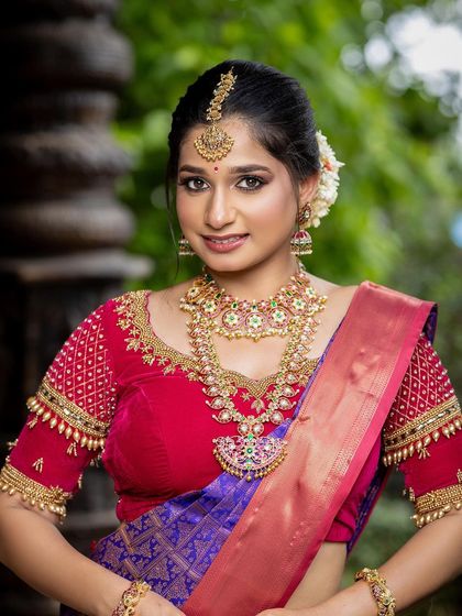 A stunning South Indian bridal portrait, with the ornate pillars of our traditional sets providing a perfect backdrop.