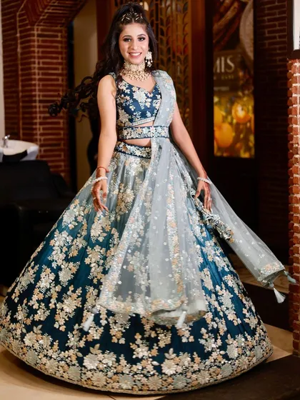 A perfect example of a complete engagement look. This client is wearing a beautiful teal and silver rental lehenga from my collection, paired with glamorous party makeup and a half-up hairstyle.