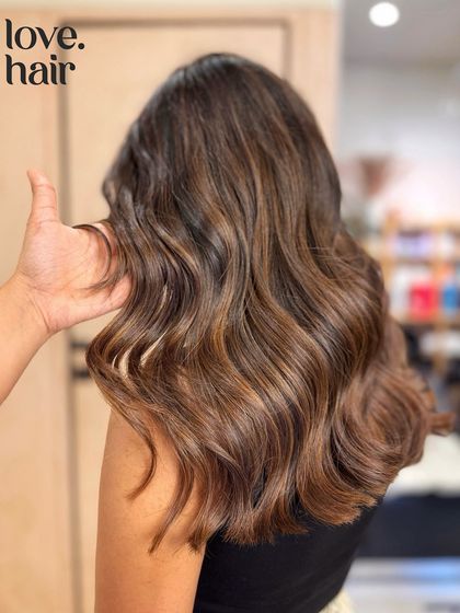 A side view of the 'chocolate lava' balayage, showing the soft waves and the beautiful, seamless blend of colour.