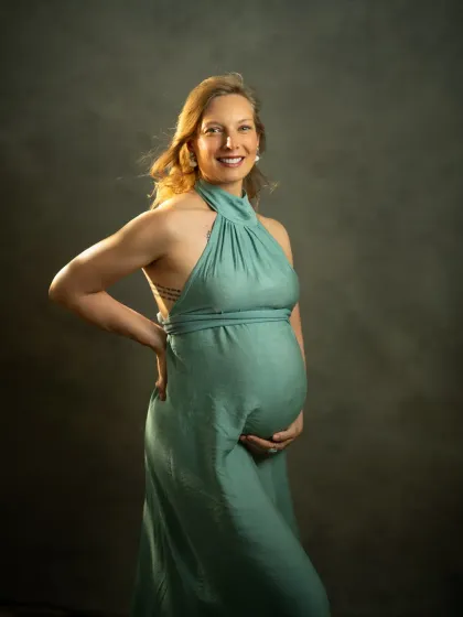 My studio sessions are designed to feel like a fine art sitting. This portrait of Sonia in a flowing green gown against a moody, classic backdrop highlights the elegance and strength of motherhood. The lighting is carefully shaped to create a painterly, three-dimensional feel.