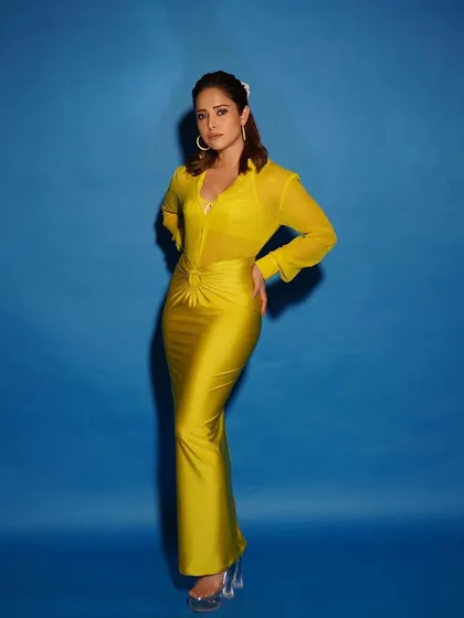 Bright, bold, and beautiful. This yellow Nidhi and Mahak dress with its sheer shirt and satin skirt is the perfect modern outfit for a cocktail party or a stylish evening out.