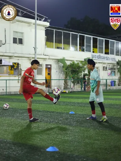 Two players practicing ball control drills in front of the David Kerrigan Youth Hostel. Our residential setup means you live and breathe football 24/7.