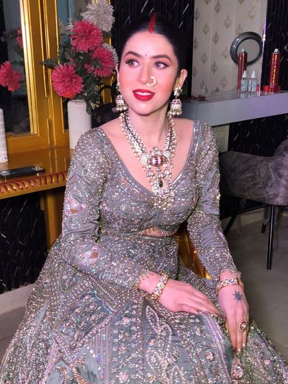 A candid moment showing off the beautiful makeup and jewelry.