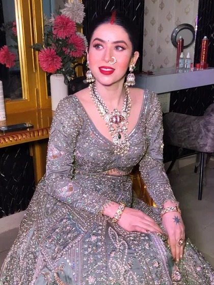 A candid moment showing off the beautiful makeup and jewelry.