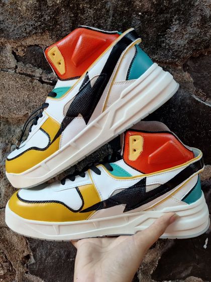 An abstract, colorful custom on a pair of chunky high-top sneakers.