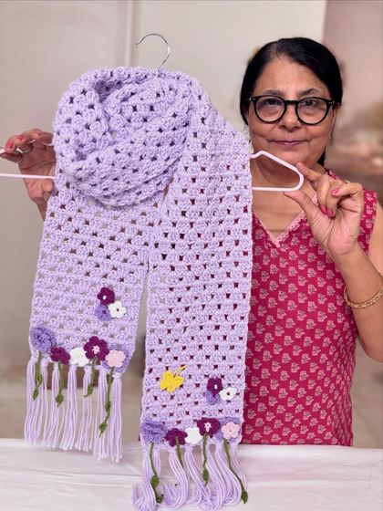 A detailed view of the lavender crochet scarf. The small flowers require a thin hook and a very attentive eye, but the satisfying result is worth the effort.
