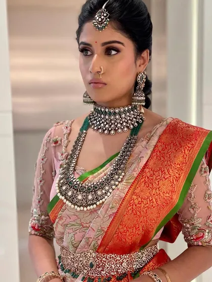 A modern take on a traditional look. The oxidized silver jewelry is the star, so I paired it with clean, defined eye makeup and a soft, neutral lip.