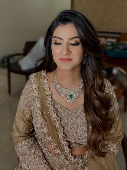 A soft glam look perfect for a wedding guest or bridesmaid. The focus is on a shimmering neutral eye, flawless skin, and a beautiful hairstyle with soft waves.