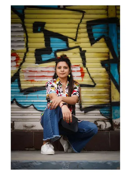 The city is my studio. I love using the textures, colors, and energy of the streets to create portraits that are vibrant and full of life. This shot against a graffiti wall shows how we can turn any corner into a dynamic backdrop.