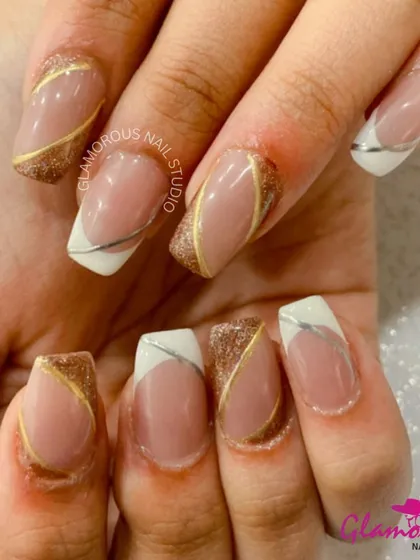 Why choose one metal when you can have both? This modern French manicure features a white tip and a nude base, with abstract, intersecting lines of gold and silver glitter for a chic, mixed-metal effect.