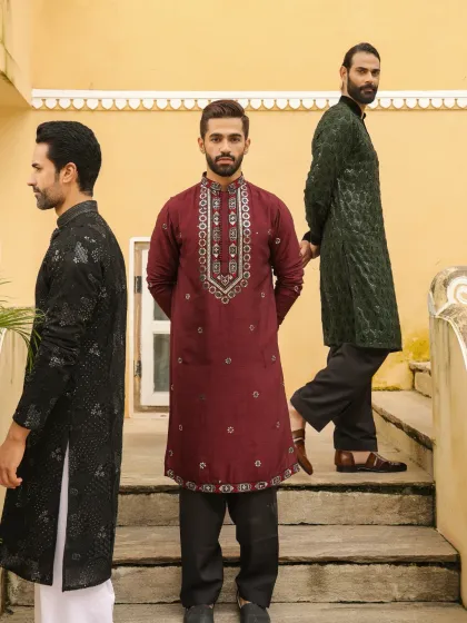 Tradition that stands out. We offer a variety of embroidered kurta sets perfect for any festive occasion, seen here in rich maroon, elegant black, and deep forest green, each with a unique neckline and pattern.