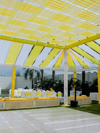 The overhead decor for the Haldi ceremony, with yellow and white drapes creating a beautiful canopy for the outdoor event.