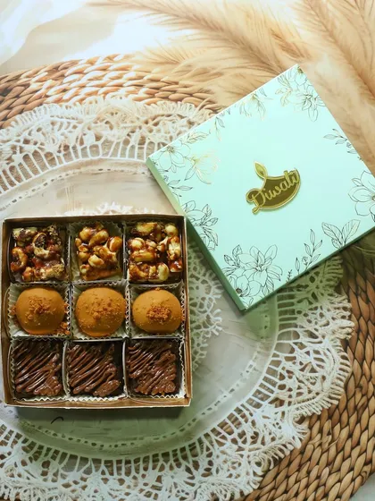 My fusion mithai box is where tradition meets modern taste. This one features my popular Biscoff Besan Laddus, Nutella Brownie Squares, and crunchy nut bars, all packed in a beautiful festive box.