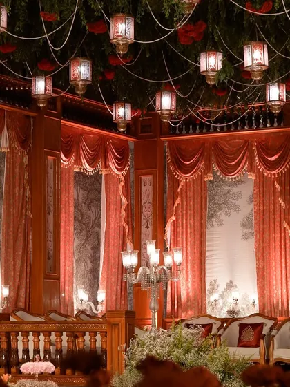 The venue was bathed in a warm, red glow, enhancing the theatrical and regal ambiance of the evening.