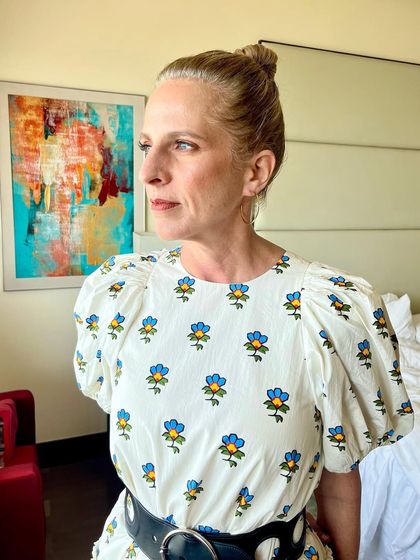 A profile view of the clean makeup and elegant top knot. This look is all about understated sophistication.