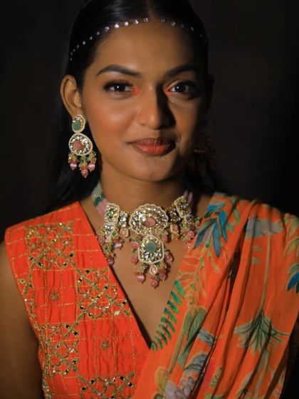 A smiling portrait of the model, highlighting the beautiful colors and craftsmanship of the choker and matching earrings.