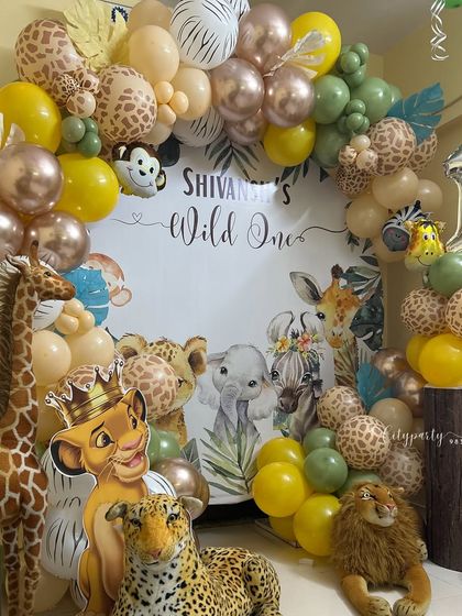 Another angle of the jungle safari first birthday, showing the Simba cutout and giraffe prop.