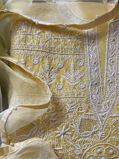 A cheerful yellow silk chanderi suit, featuring the same heavy Chikankari, sequin, and seed pearl embellishments as its sister pieces.