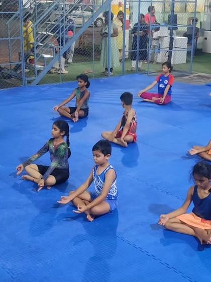 Finding focus together. Our gymnasts practicing group meditation at the end of a session to build mental strength and silence, a key part of our training philosophy.