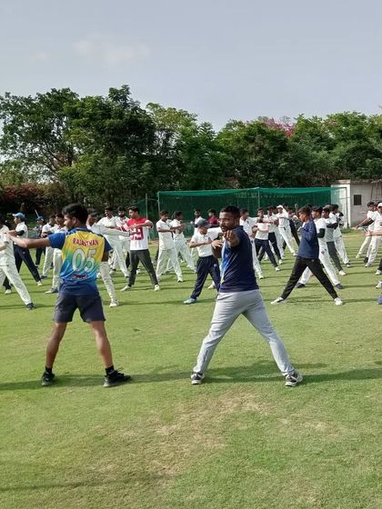 A yoga session in progress on the field. We incorporate yoga into our training for improving flexibility, balance, and mental focus, as well as aiding in muscle recovery after intense sessions.