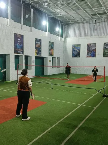 Intense focus during a mixed doubles game. The players are ready to return a fast shot at the net.