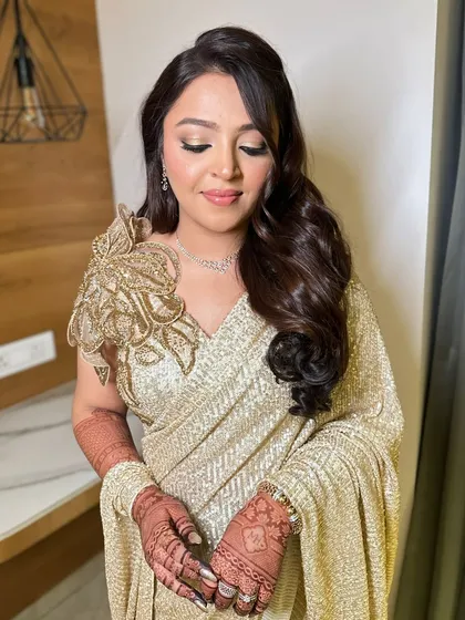 A beautiful still of Mehek's golden Sangeet look. The soft waves in her hair and the shimmering makeup create a look that is both glamorous and sophisticated.