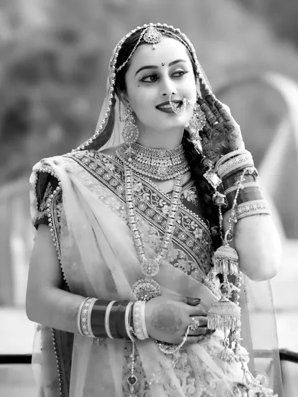 A candid black and white photo of the bride, capturing a natural and happy expression.