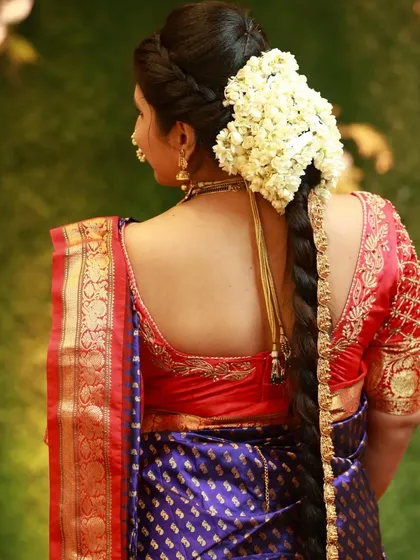 A traditional bridal hairstyle is just as important as the makeup. Here is a classic South Indian braid, beautifully woven and adorned with fresh jasmine flowers (gajra), perfect for a traditional wedding ceremony.