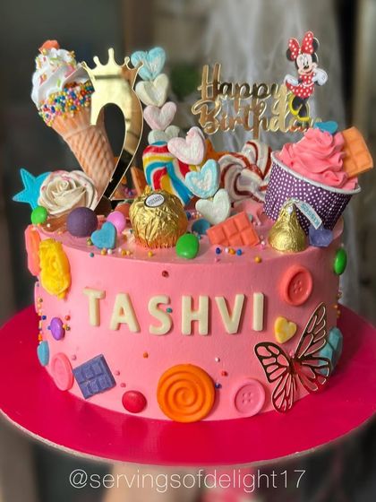 Welcome to Candyland! This cake is a dream for any child with a sweet tooth, decorated with lollipops, ice cream cones, and lots of colorful candies.