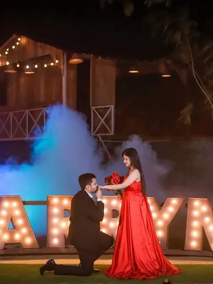 A dramatic proposal shot using our 'MARRY ME' letters, with blue and white smoke effects creating a dreamy, ethereal backdrop. This style is ideal for couples looking for a high-impact engagement announcement photo.
