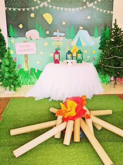 A fun camping-themed birthday party setup. I created a faux bonfire and campsite scene to bring the great outdoors inside for an adventure.