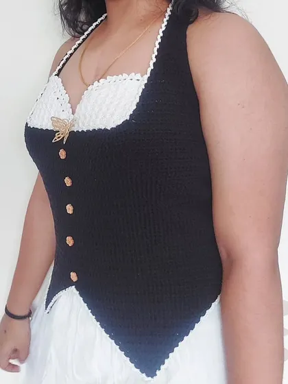 A side view of the Belladonna Top, highlighting its flattering silhouette and the contrast between the black and white sections.