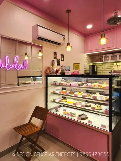 Another view of the neon sign and display counter. The lighting is designed to be soft and flattering, highlighting the baked goods and making the space feel warm and welcoming.