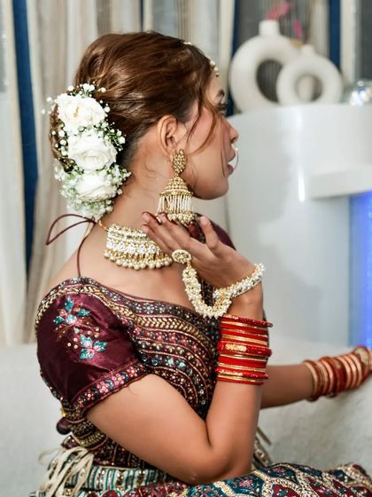 This twisted floral bun is a work of art. The combination of white roses and baby's breath creates a look that is both classic and breathtaking.