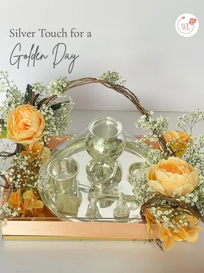 For a touch of timeless tradition, I create these stunning silver tray arrangements. This hamper features a set of pure silver-plated items, beautifully adorned with fresh, delicate flowers like peonies and baby's breath, making for a truly golden gift.