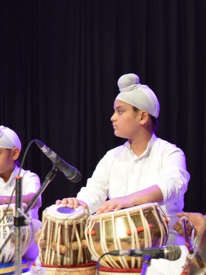 A student concentrating on his performance during our annual concert. Each student gets the opportunity to perform on a professional stage.