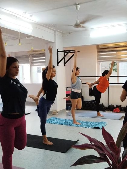Students in our morning class practicing Natarajasana (Dancer's Pose), a beautiful posture that challenges balance and opens the shoulders and chest.